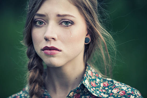 Sad beauty Portrait of a sad young woman with a braid, crying. women crying stock pictures, royalty-free photos & images