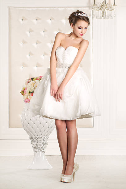 istock Gorgeous bride with white dress with flowers bouquet 504682367