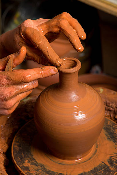 istock hands of a potter, creating an earthen jar 504682457
