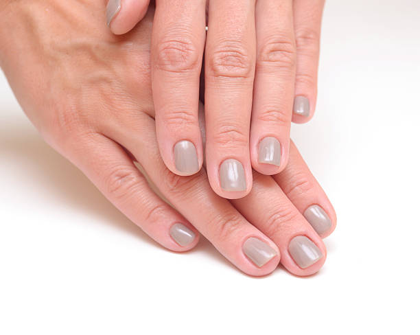 istock hands with woman's professional grey nails manicure isolated 504683379