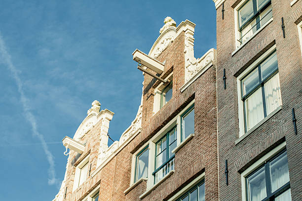 Amsterdam houses Architectural detail of traditional canal hoeses in Amsterdam hook of holland stock pictures, royalty-free photos & images