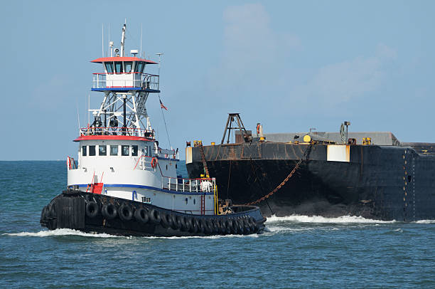 Ocean Tugboat Pulling Barge stock photo