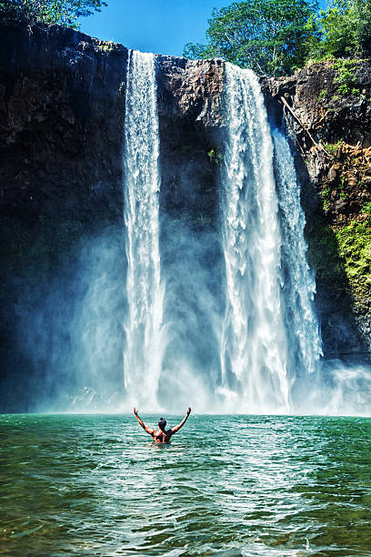 Man Swimming at Wailua Falls stock photo