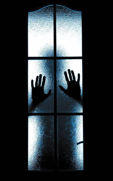 istock Scared boy behind glass door 504685261