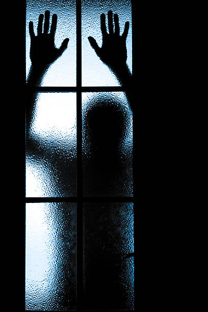 istock Scared boy behind glass door 504685551