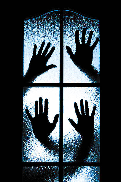 istock Scared boy behind glass door 504685595