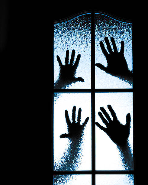 istock Scared boy behind glass door 504685693