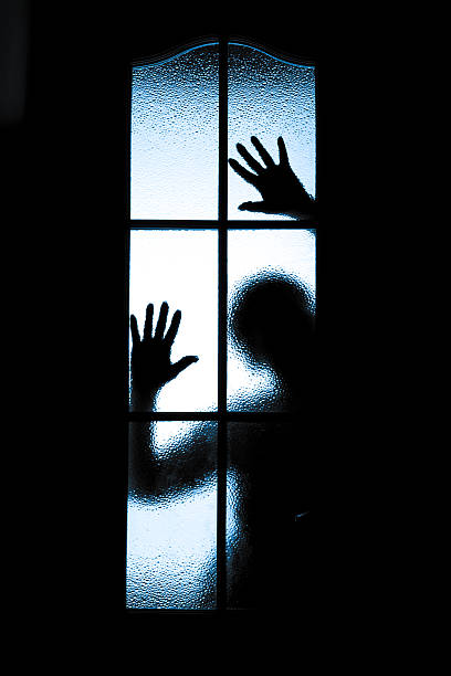 istock Scared boy behind glass door 504685705