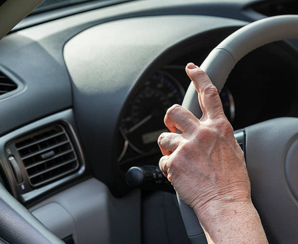 istock Woman's Hand on Car Steering Wheel 504686619