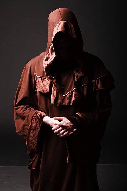 istock Mystery monk praying on kneels 504687509
