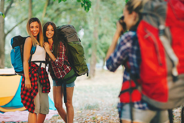 istock Young backpackers photographing in nature 504694442