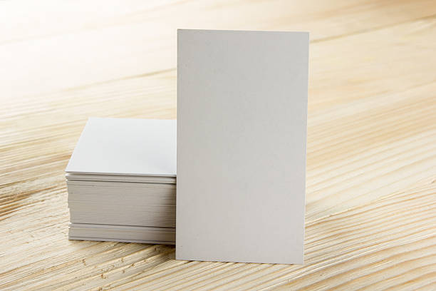 istock White blank business visit card, ticket, pass, present  wooden background 504694448