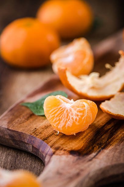 istock orange isolated on wood background 504695058