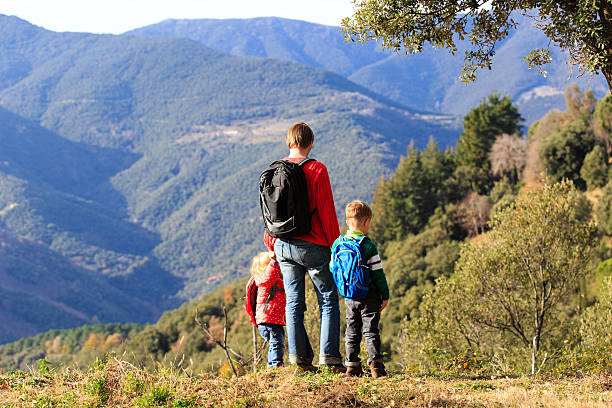 istock father with two kids travel in mountains 504695412