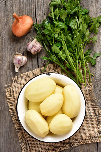 Peeled raw potatoes and vegetables, top view