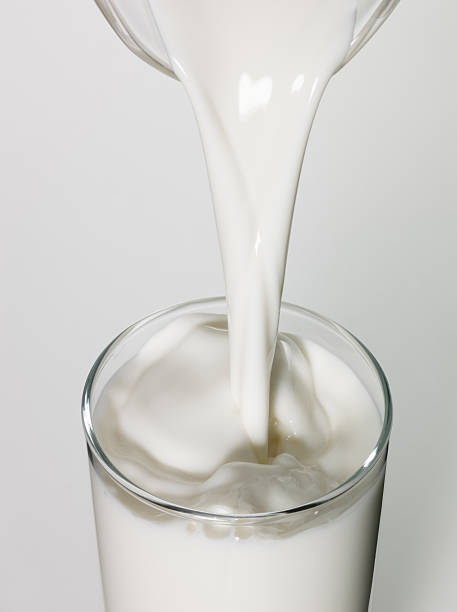 istock Milk being poured in a glass, close up 504696588