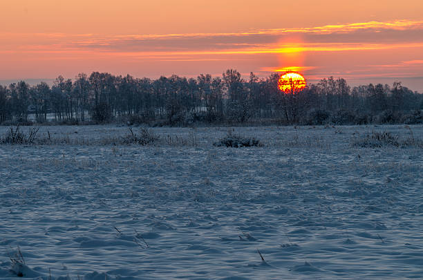 istock sunrise at snowy frosty field 504697674
