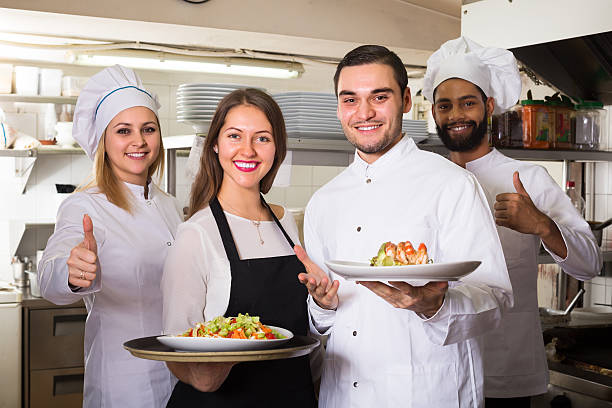 istock Waitress and cooking team in restaurant 504697986