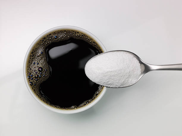 istock Spoon of sugar above a cup of coffee 504698536