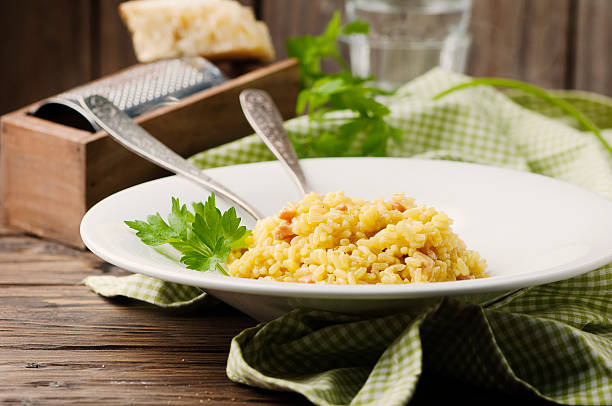 istock Italian traditional risotto with saffron and ham 504698824