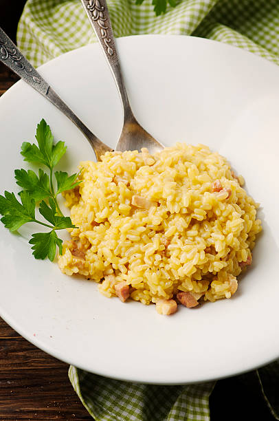 istock Italian traditional risotto with saffron and ham 504698966