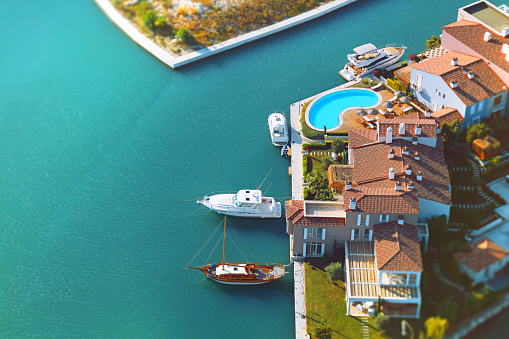 aerial view group of houses with pool and yachts shot from air