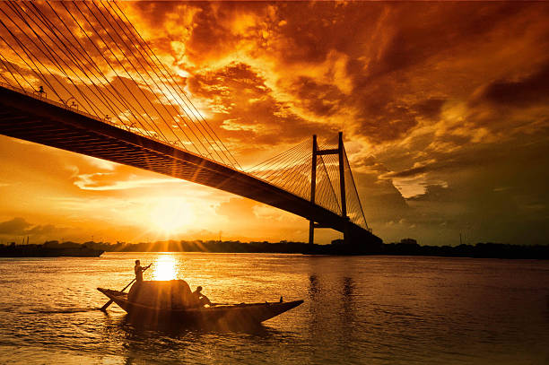 The last Sailor's Sunset Shot at prinsep ghat near the banks of the Ganges. The bridge is Vidyasagar setu that connects Kolkata and Howrah. kolkata stock pictures, royalty-free photos & images