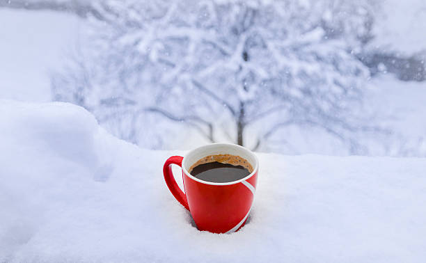 istock Hot cup of coffee on snow 504703214