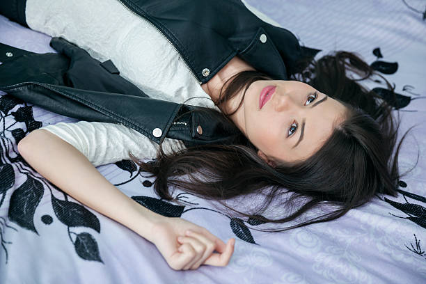 istock Beautiful casual dressed girl lying on her back looking up 504703406