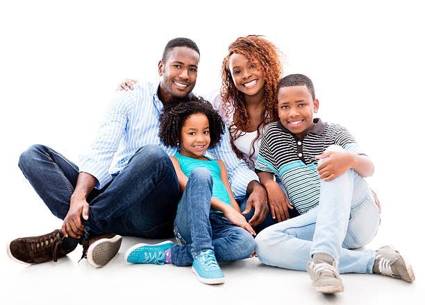 Happy black family Happy black family sitting on the floor - isolated over white four people photos stock pictures, royalty-free photos & images