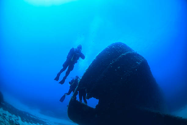 istock Scuba Diving   Wreck divers over a shipwreck 504705657