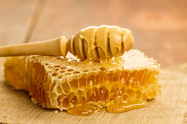 istock fresh honey and drizzler on a wooden background. 504706010