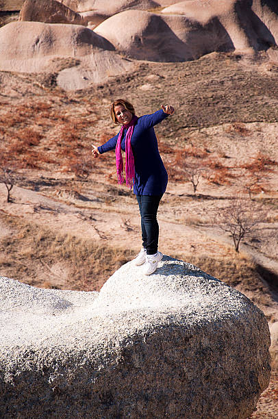 istock happy lady with open arms on  the rock 504706576