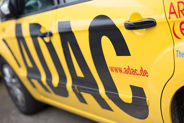 Side view of yellow ADAC service car Hamburg, Germany - May 29, 2014: Side view of a parking ADAC car in Hamburg, Germany. adac stock pictures, royalty-free photos & images