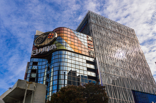 Tokyo, Japan - November 21, 2015: Ginza district in Tokyo. The Ginza is Tokyo's most famous upmarket shopping, dining and entertainment district, featuring numerous department stores, boutiques, art galleries, restaurants, night clubs and cafes. One square meter of land in the district's center is worth over ten million yen, making it one of the most expensive real estate in Japan. It is where you can find the infamous $10 cups of coffee and where virtually every leading brand name in fashion and cosmetics has a presence.