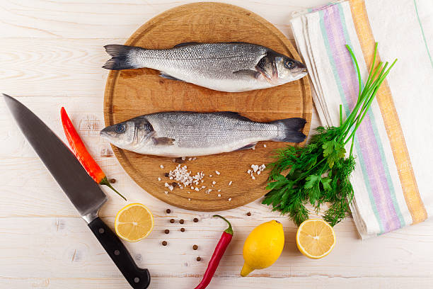 istock Two fresh sea bass on a white background. Top view. 504707508