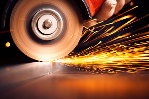 istock Red hot sparks at grinding steel material 504707691