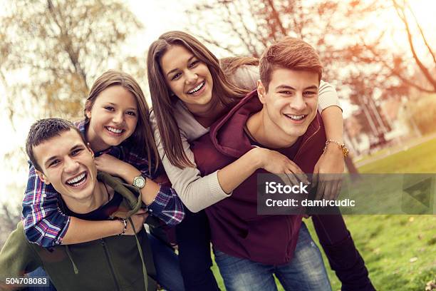 Group Of Happy Teenage Friends Having Fun Stock Photo - Download Image Now - Teenager, Happiness, Outdoors