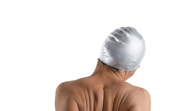 istock female swimmer's back in studio white background 504708502