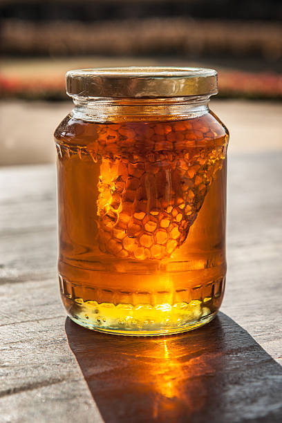 istock Honeycomb in honey Jar on the table 504708928