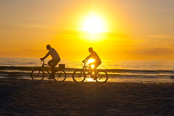 istock Couple Biking at Sunset on the Beach 504709306
