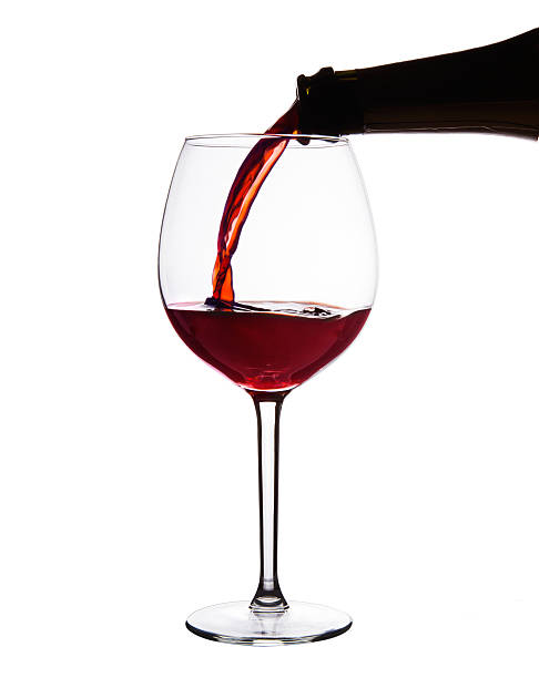istock Red wine pouring into wine glass. isolated with Clipping path. 504709573