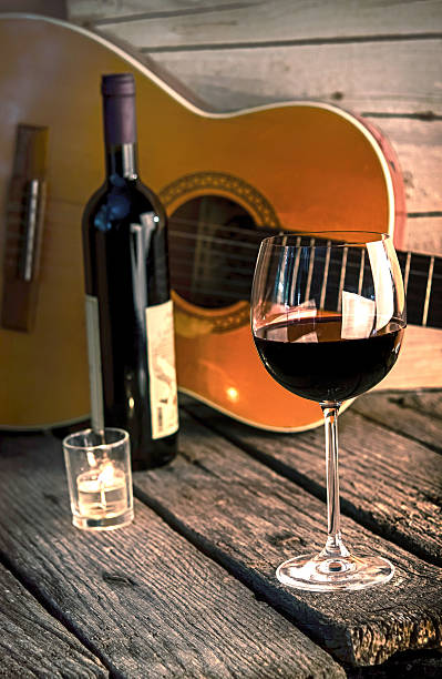 guitar and Wine on a wooden table romantic dinner background stock photo