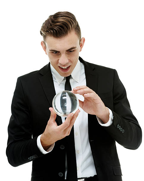 istock Businessman looks into the future with crystal ball 504710161