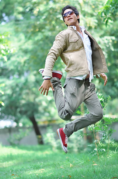 istock Young man Jumping in park 504710281