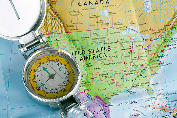 istock Closeup shot of compass on colorful map 504710299