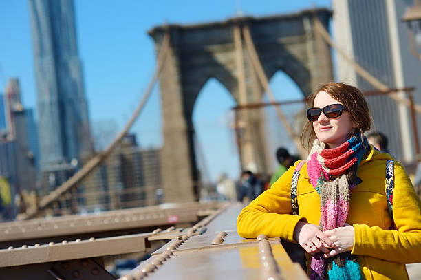 istock Young woman sightseeing on Brooklyn Bridge 504710394