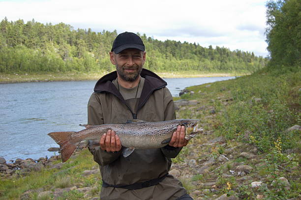 istock Fisherman caught a big salmon. 504710686