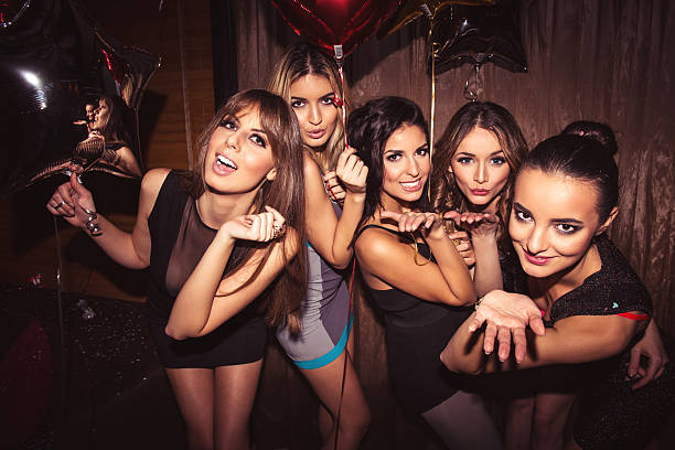 Enjoying the nightlife Group of girls blowing kisses at a camera. drunk photos stock pictures, royalty-free photos & images