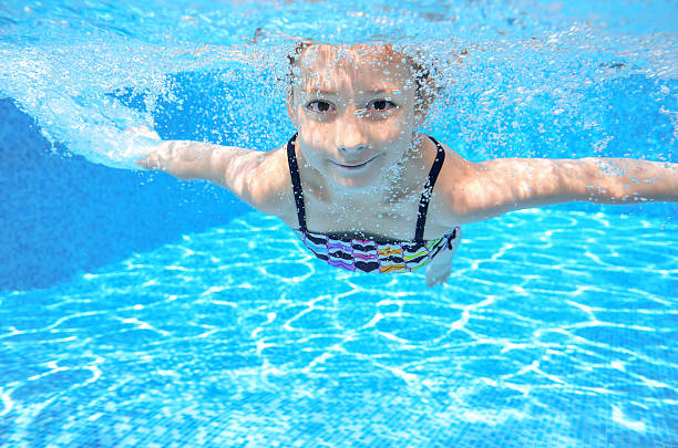 istock Happy active underwater child swims in pool 504738133